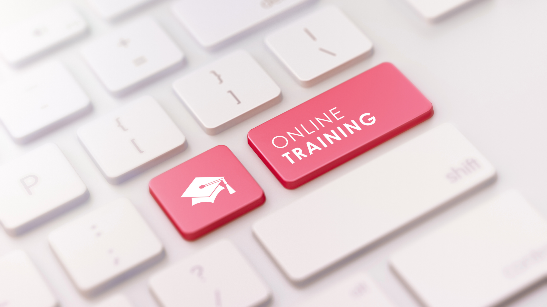 Keyboard key labeled ‘Online Training,’ representing WSU EP‑14 protection‑of‑minors training for Cougs 4 Kids mentors.