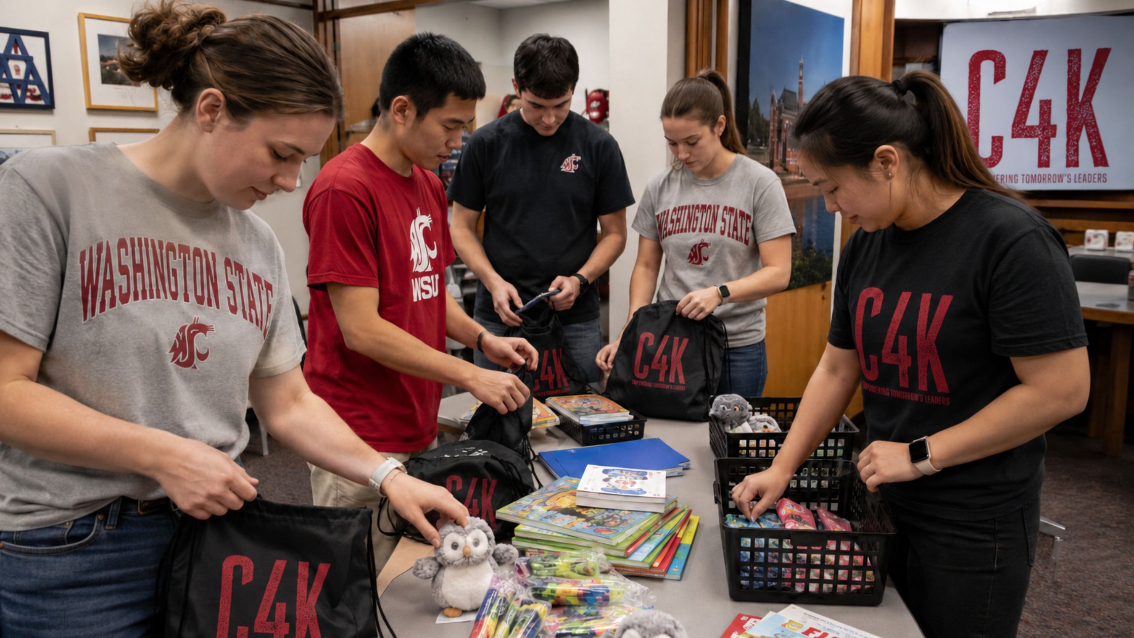 WSU students packing C4K MentorBoost Kits with books, supplies, and encouragement items